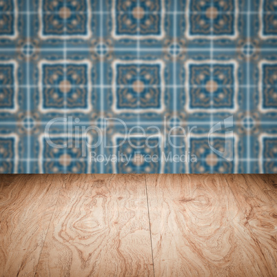 Wood table top and blur vintage ceramic tile pattern wall