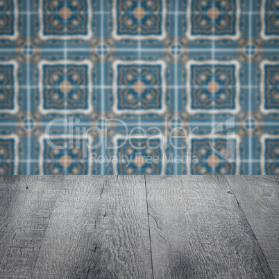 Wood table top and blur vintage ceramic tile pattern wall