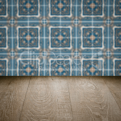 Wood table top and blur vintage ceramic tile pattern wall