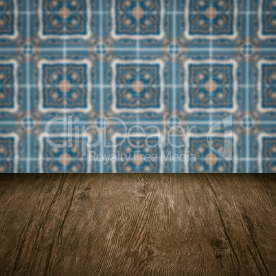 Wood table top and blur vintage ceramic tile pattern wall