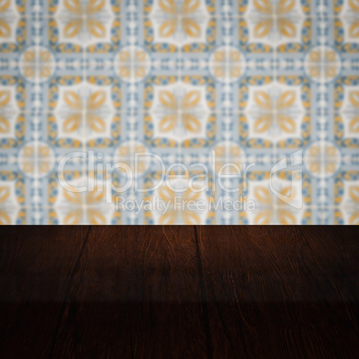 Wood table top and blur vintage ceramic tile pattern wall Wood table top and blur vintage ceramic tile pattern wall