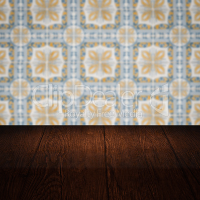 Wood table top and blur vintage ceramic tile pattern wall Wood table top and blur vintage ceramic tile pattern wall