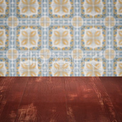 Wood table top and blur vintage ceramic tile pattern wall