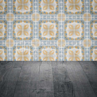 Wood table top and blur vintage ceramic tile pattern wall