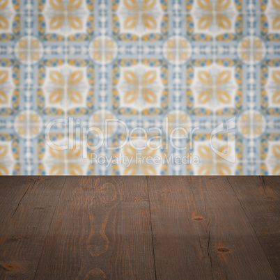 Wood table top and blur vintage ceramic tile pattern wall
