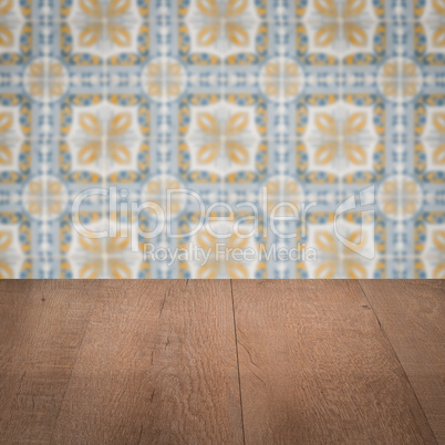 Wood table top and blur vintage ceramic tile pattern wall