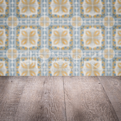 Wood table top and blur vintage ceramic tile pattern wall