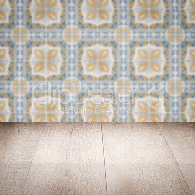 Wood table top and blur vintage ceramic tile pattern wall