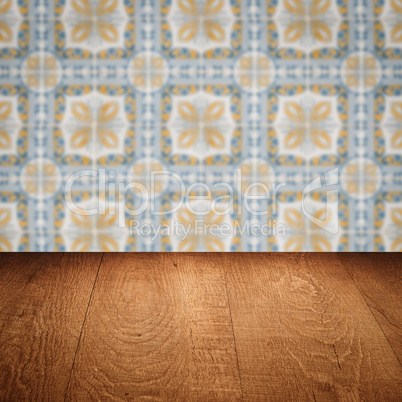 Wood table top and blur vintage ceramic tile pattern wall