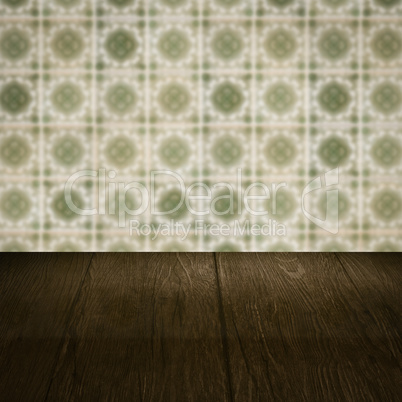 Wood table top and blur vintage ceramic tile pattern wall