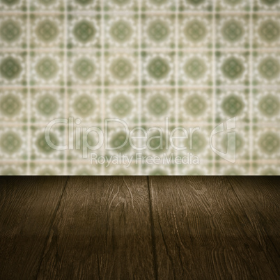 Wood table top and blur vintage ceramic tile pattern wall