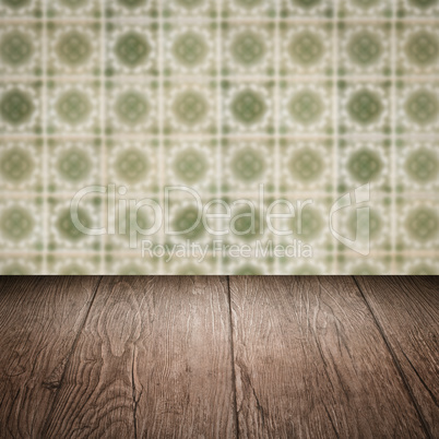 Wood table top and blur vintage ceramic tile pattern wall