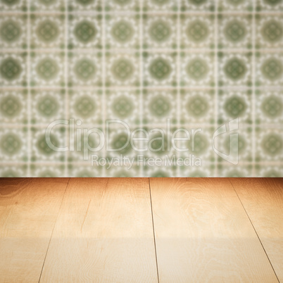 Wood table top and blur vintage ceramic tile pattern wall