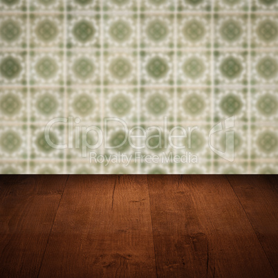 Wood table top and blur vintage ceramic tile pattern wall