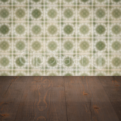 Wood table top and blur vintage ceramic tile pattern wall Wood table top and blur vintage ceramic tile pattern wall