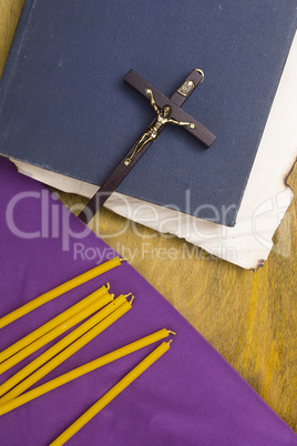 Thin candles on purple cloth used in religion