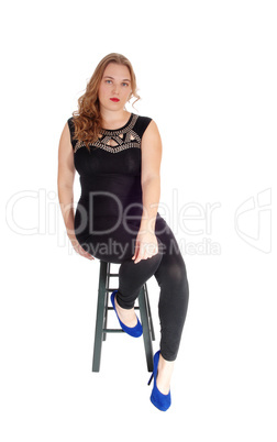 Woman sitting on chair in tights.
