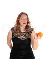 Blond woman holding two oranges.