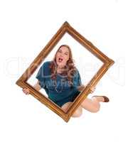 Woman sitting on floor with picture frame.