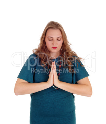 Praying woman with hands folded.