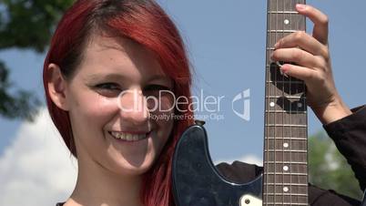 Confused Teen Redheaded Female With Guitar