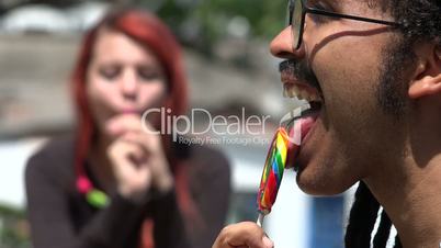 Man And Woman Eating Lollipops