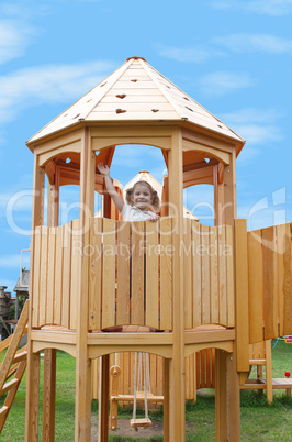 little girl standing in playground tower