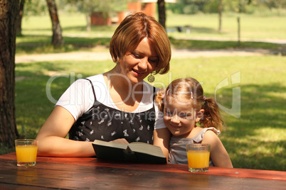 mother and daughter reading a book