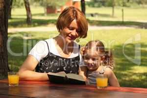 mother and daughter reading a book