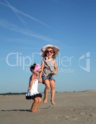 two happy little girl jumping