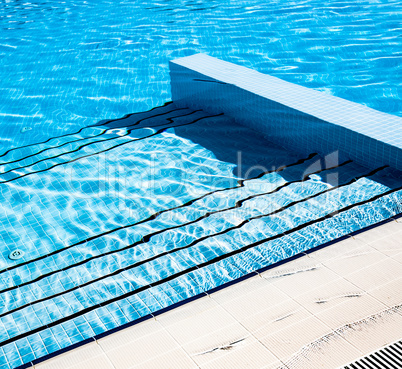 Stairs clear blue swimming pool