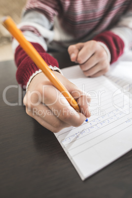 Child write in a notebook.