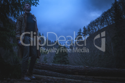 Young man in the forest at night