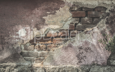 Broken plaster and brick wall