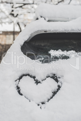 Snow heart shape on car