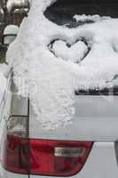 Snow heart shape on car
