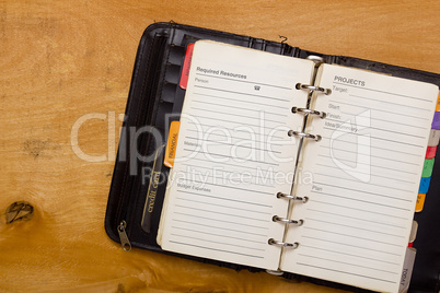 Open diary on wooden table