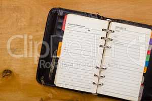 Open diary on wooden table