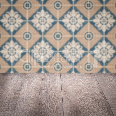 Wood table top and blur vintage ceramic tile pattern wall