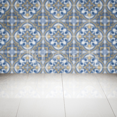 Wood table top and blur vintage ceramic tile pattern wall