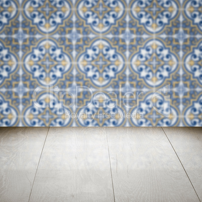 Wood table top and blur vintage ceramic tile pattern wall