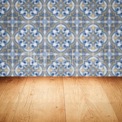 Wood table top and blur vintage ceramic tile pattern wall