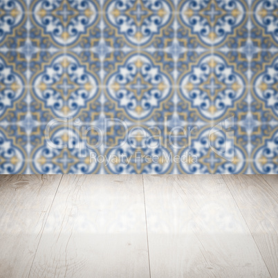 Wood table top and blur vintage ceramic tile pattern wall Wood table top and blur vintage ceramic tile pattern wall