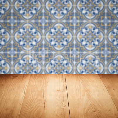 Wood table top and blur vintage ceramic tile pattern wall