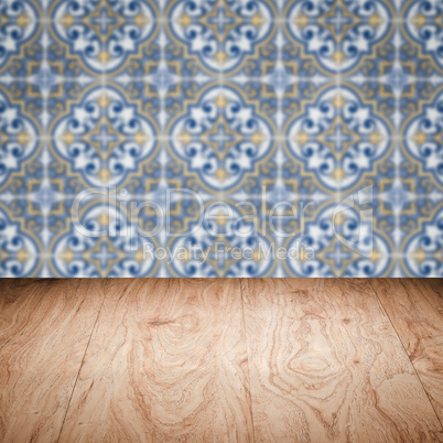 Wood table top and blur vintage ceramic tile pattern wall