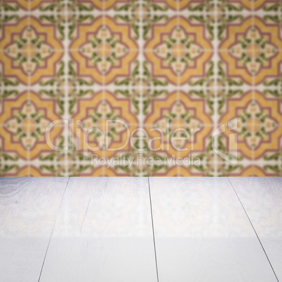 Wood table top and blur vintage ceramic tile pattern wall