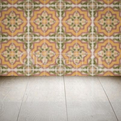 Wood table top and blur vintage ceramic tile pattern wall