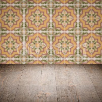 Wood table top and blur vintage ceramic tile pattern wall