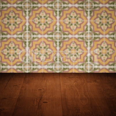 Wood table top and blur vintage ceramic tile pattern wall