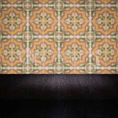 Wood table top and blur vintage ceramic tile pattern wall